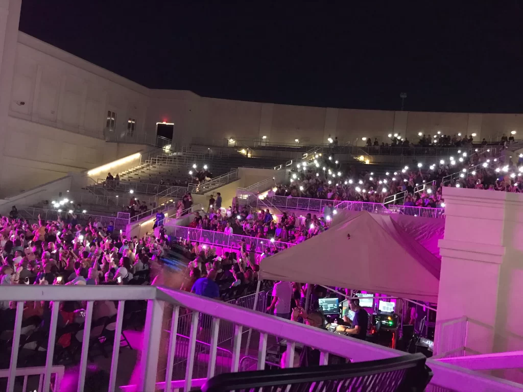 The Orion Amphitheater crowds enjoying live music and illuminated phone flashlights
