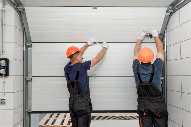 Workers are installing lifting gates of the garage.